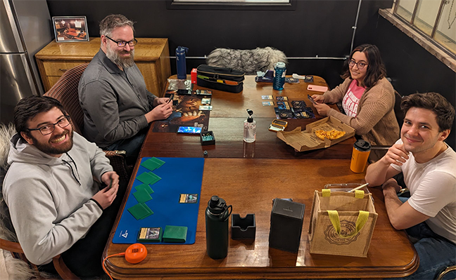 TCG Machines staff playing Lorcana